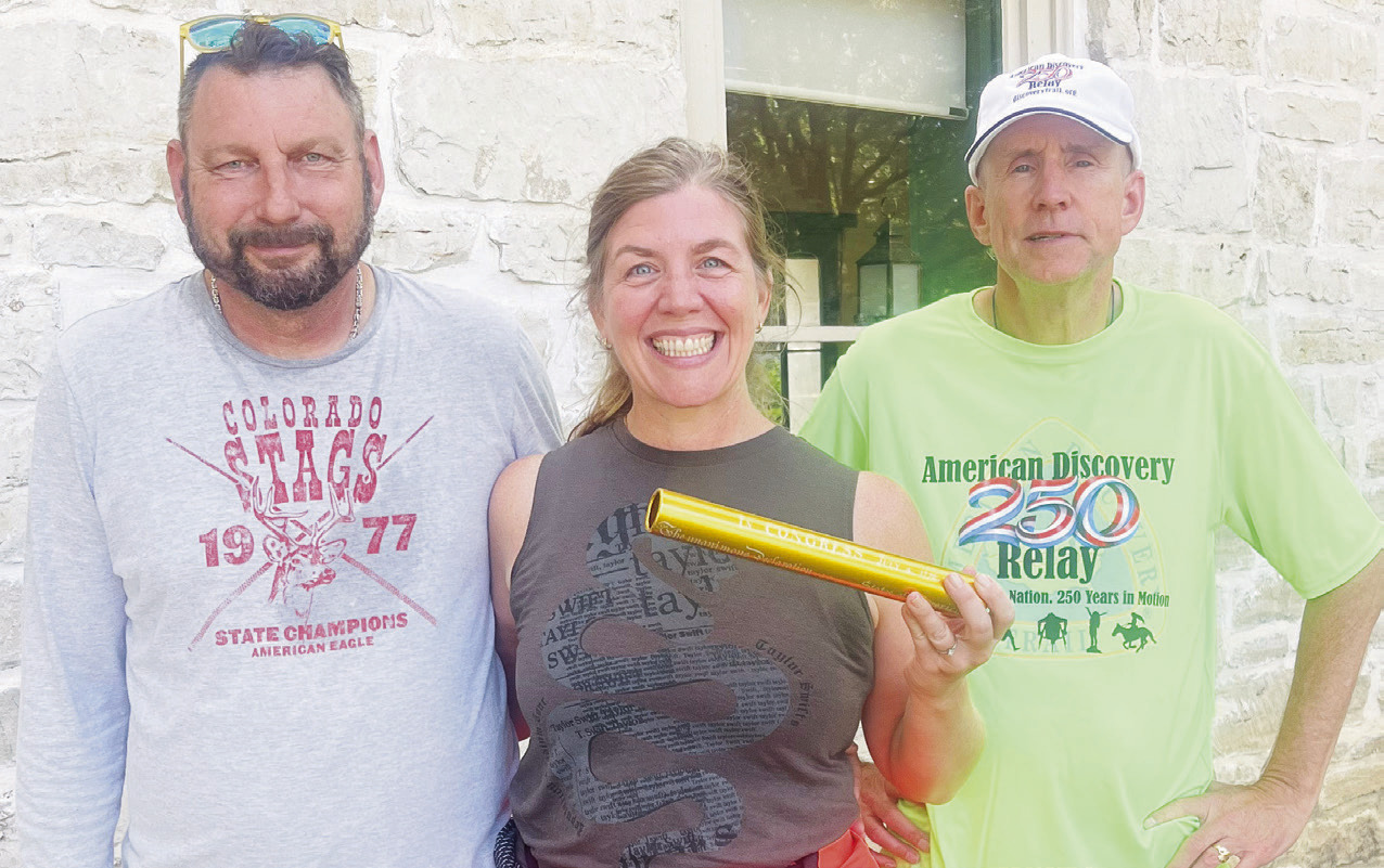 Bill and Katie Allen of Manhattan provided an important link in the nationwide Discovery 250 Relay on Monday, carrying the baton from Herington to Council Grove by bicycle. After receiving the baton in Herington, the couple rode to Council Grove, where they handed it off to relay coordinator Mike Leland (right). The baton leaves Council Grove early this morning, traveling through Allegawaho Memorial Heritage Park and along the Flint Hills Trail.