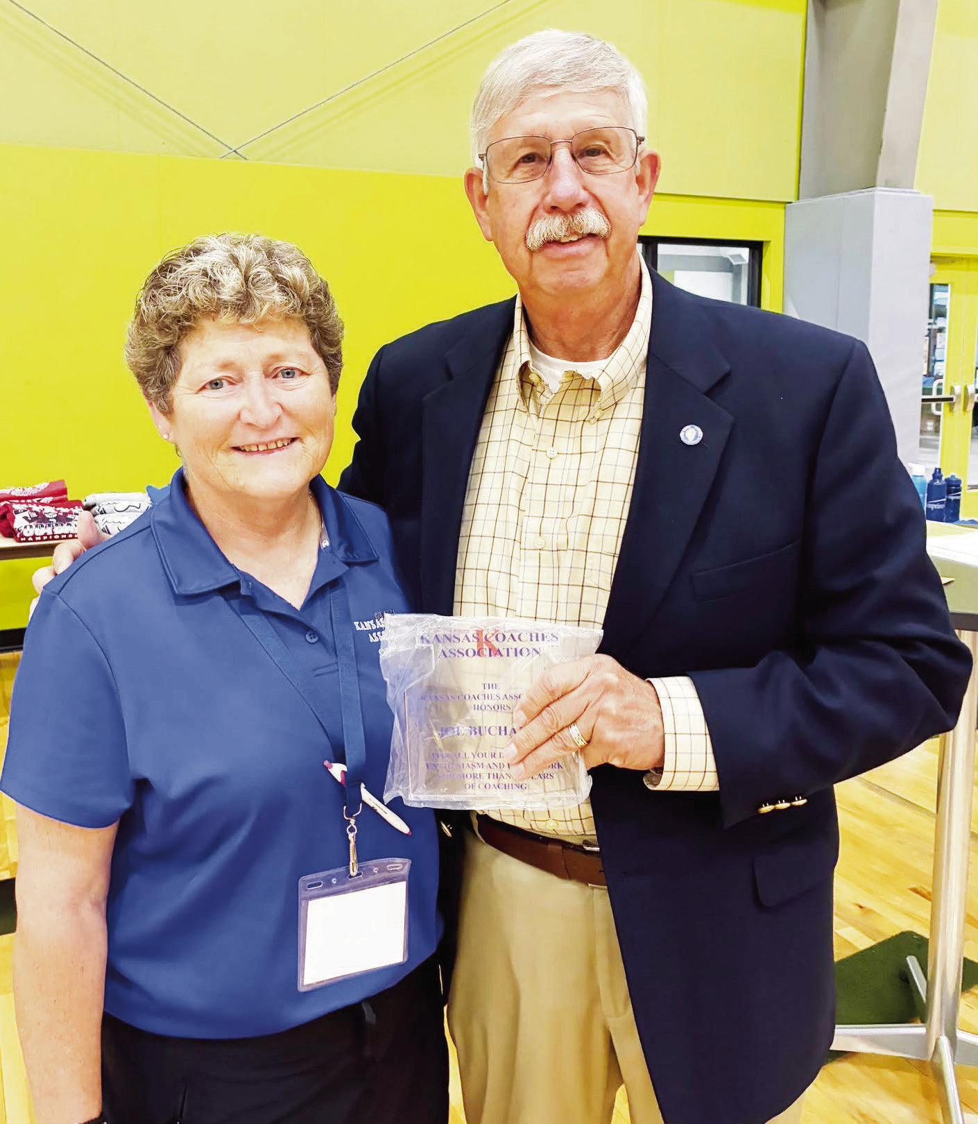 Council Grove’s Joe Buchanan was honored for his 50+ years of coaching service during a KSHSAA Coaching School. He is pictured with Jackie Hall, president of the Kansas Coaches Association.