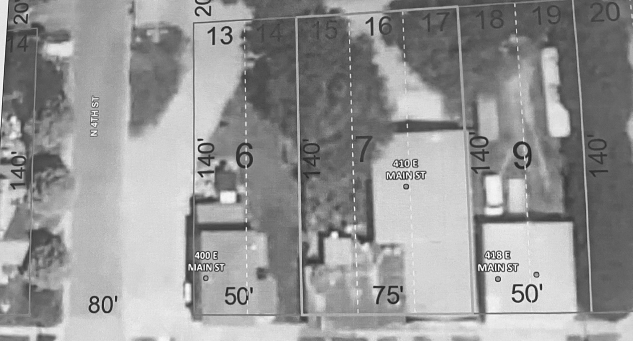An aerial view of 410 E. Main (middle of the photo) shows the intermingling of rooflines. City inspectors view the property as two buildings while Sage Homes, the contractor for owner Tim Walsh views the site as one building.