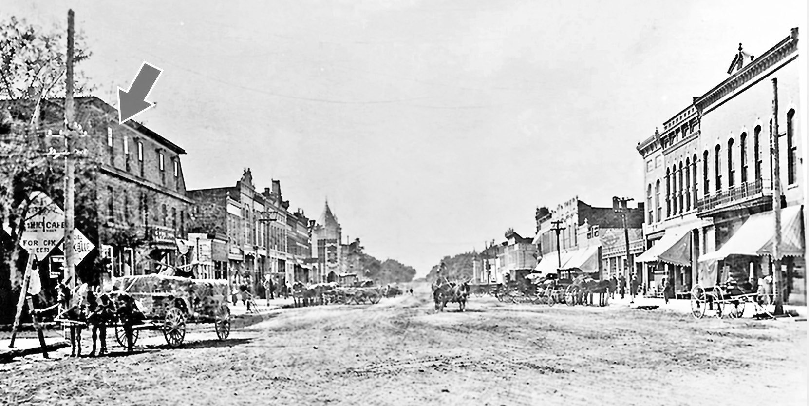 The building marked with the arrow was built as the Gilkey House during 1856-1859. It was later known as the Commercial Hotel and the Somnus Hotel before it was torn down in 1939 to make room for the present U. S. Post Office in Council Grove.
