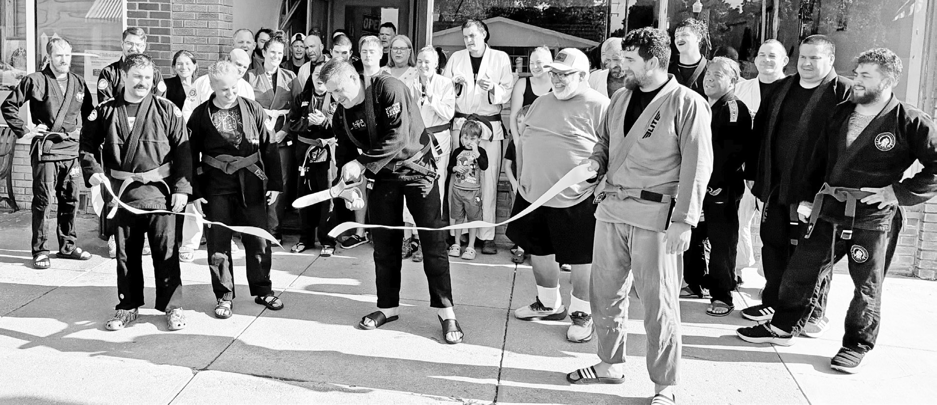 Eric Brown ceremonially cut the ribbon Sunday afternoon to celebrate the dojo’s presence at 231 W. Main, Council Grove where Brazilian Jiu-Jitsu for every body and every level is taught. Friends, residents and Jiu-Jitsu team members participated in the Sunday, September 13, 2026 celebration.