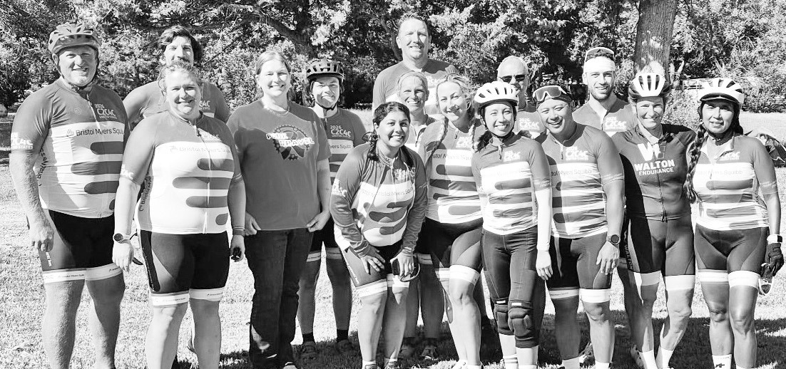 Amy Oleen-Naaf, second from left on the front row and Karen Bliss, a United States Bicycling Hall of Fame inductee and second from right in the back row, pose with the Gale Force Five national cycling team and its coaches during a stop in Dwight. Naaf and Bliss became friends after a chance meeting in 2025.