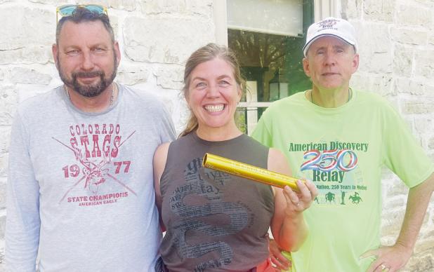 Bill and Katie Allen of Manhattan provided an important link in the nationwide Discovery 250 Relay on Monday, carrying the baton from Herington to Council Grove by bicycle. After receiving the baton in Herington, the couple rode to Council Grove, where they handed it off to relay coordinator Mike Leland (right). The baton leaves Council Grove early this morning, traveling through Allegawaho Memorial Heritage Park and along the Flint Hills Trail.