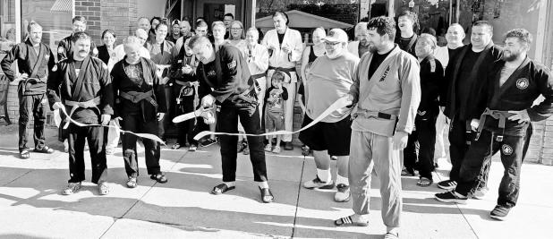 Eric Brown ceremonially cut the ribbon Sunday afternoon to celebrate the dojo’s presence at 231 W. Main, Council Grove where Brazilian Jiu-Jitsu for every body and every level is taught. Friends, residents and Jiu-Jitsu team members participated in the Sunday, September 13, 2026 celebration.