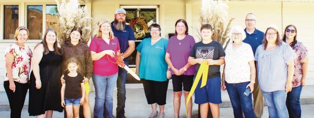 Community leaders, friends and family gathered at Tallgrass Insurance Group, 623 E. Main, Council Grove on Tuesday to celebrate a ribbon cutting of agent Anna Romme’s agency. Pictured from left are - back row: Julie Hower, Sara Wheeler, Morgan Romme, Anna Romme, Brian Romme, Kim Metcalfe, Dee Geiswein, Reed Romme, Donna Bundy, (Behind Donna) Nick Jones, (to the right of Donna) Mallory Lee and Courtney Jackson; front row: Kodi Romme. (Photo by Mindy Andres)