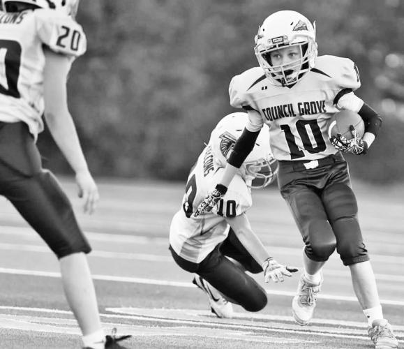 Council Grove 5th grader, Brody Jarvis, breaks tackles and rushes for 174 yards in the 5th grade win over Riley County.