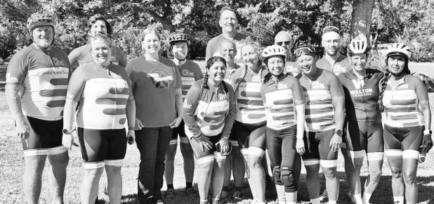Amy Oleen-Naaf, second from left on the front row and Karen Bliss, a United States Bicycling Hall of Fame inductee and second from right in the back row, pose with the Gale Force Five national cycling team and its coaches during a stop in Dwight. Naaf and Bliss became friends after a chance meeting in 2025.