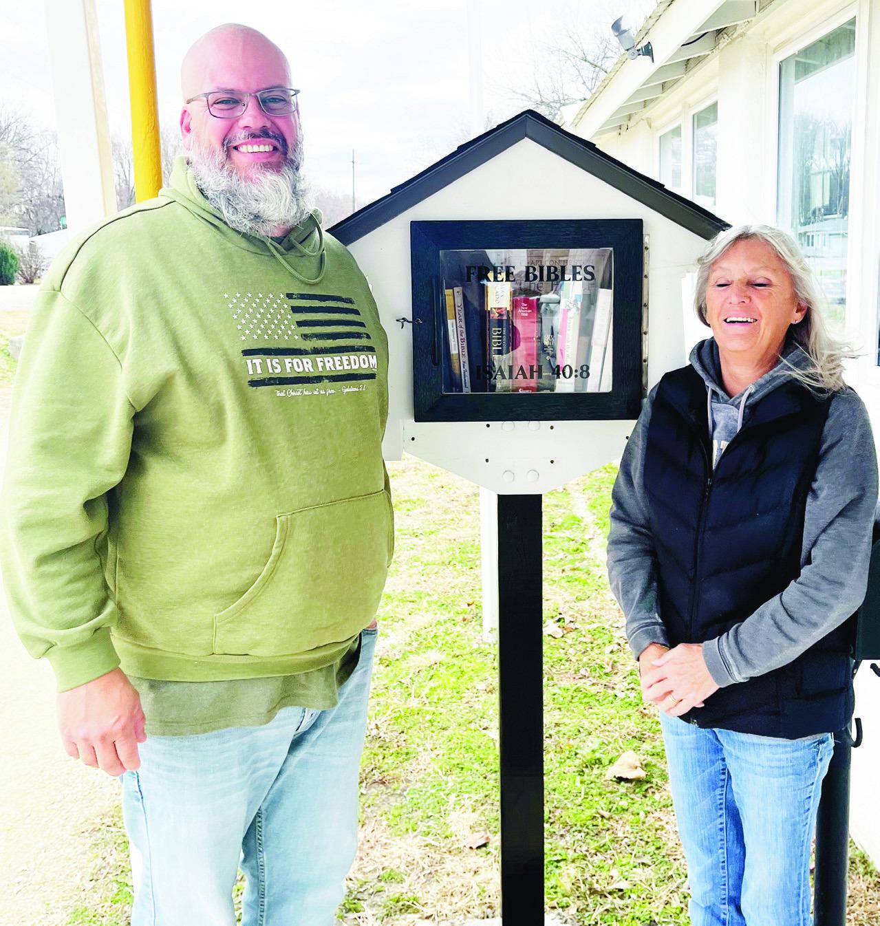 Travis Richardson (left) built the Community Thrift Store’s new Bible House after his mother, Sharmon Richardson, a board member, wondered if he might be willing to take on the project. Larry Rose, not pictured, installed the post, and Deb Meierhoff com