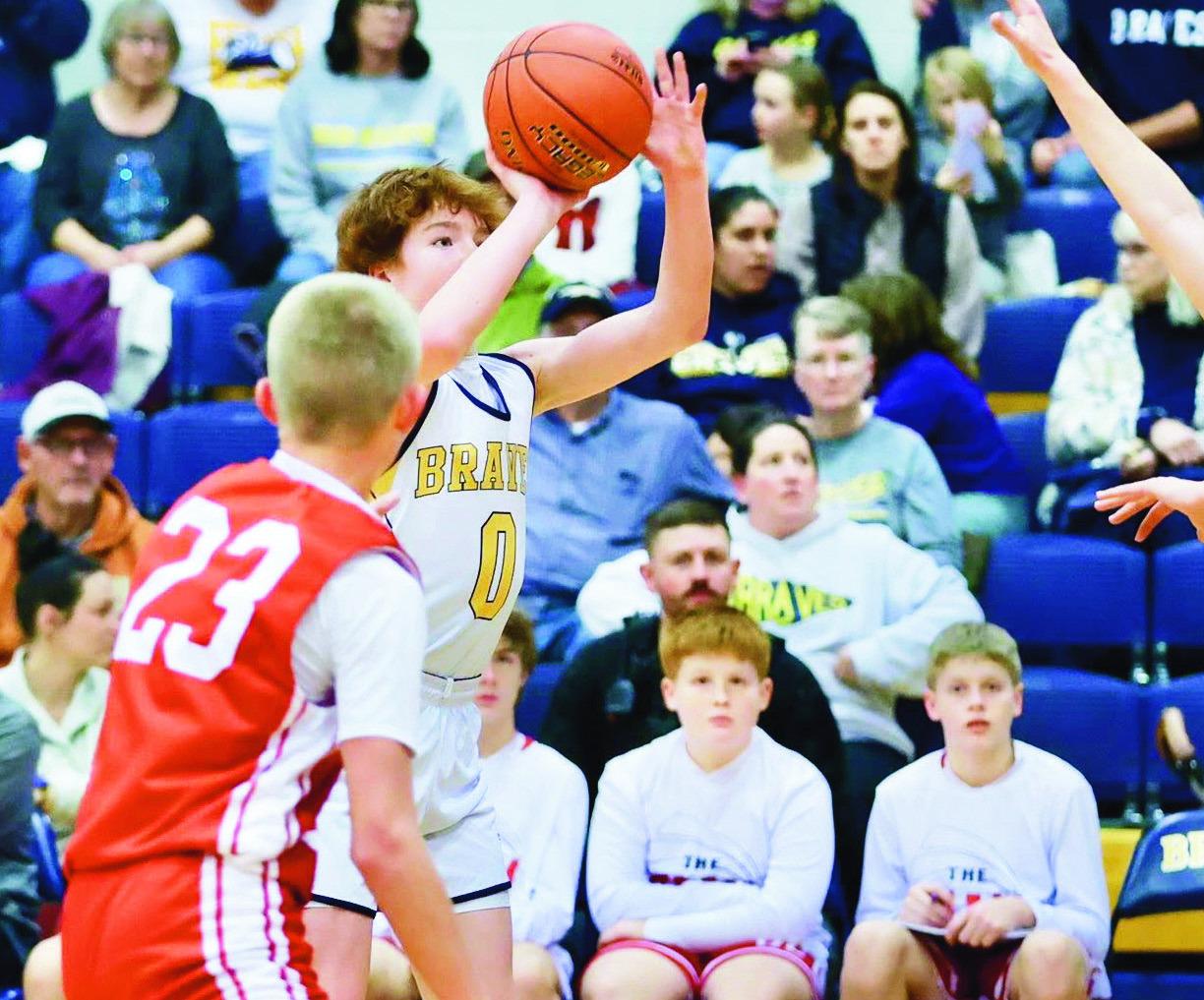 HILTON GOES FOR TWO -- Brantley Hilton goes up for two of his game high 13 points here Tuesday night as the Council Grove Junior High Braves defeat Osage City 37-26. (Photo by Brandy Villalobos)