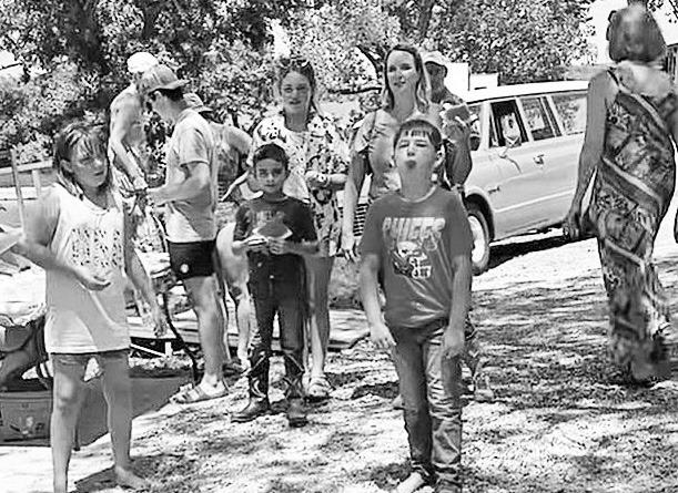 CHAMPION SPITTER -- Dalton Amick, age 7 of Alma, launches a watermelon seed 12’ 7” for first place in the 7 and under division at the Council Grove Marina’s watermelon seed spitting contest on Saturday.