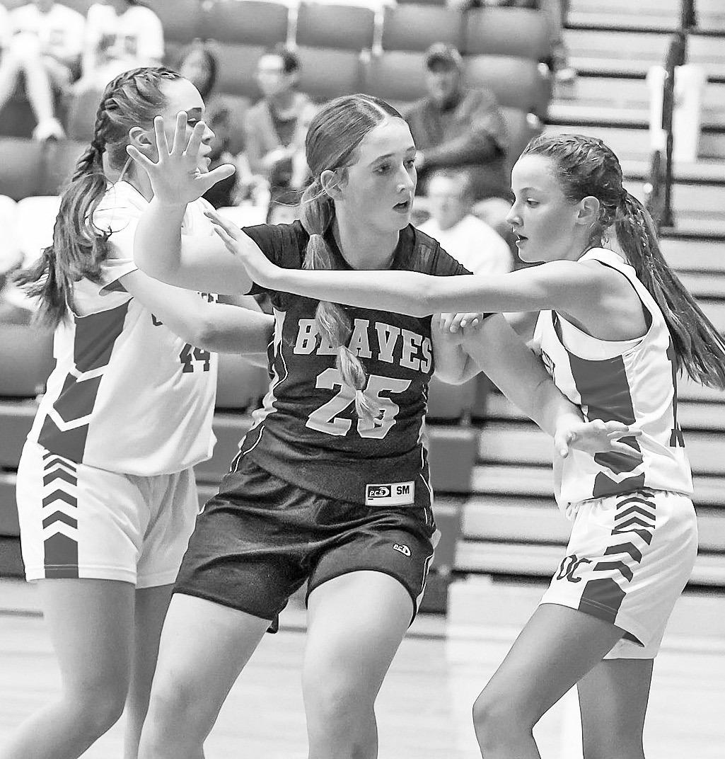 Council Grove eighth grader Declan SanRomani works to get open against two defenders as she goes on to score 10 points against Osage City Monday night. The Junior High Lady Braves were defeated 30-19. Next up for the CGJH is West Franklin at home tonight.