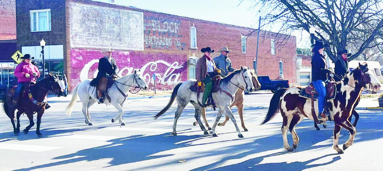 LAID TO REST. . . Frankie J. Buchman was honored by local ranchers and horsemen with a procession Thursday from St. Rose Catholic Church to Calvary Cemetery at Council Grove’s western limit. The horse drawn hearse, or carriage, is owned by Kevin Brown o