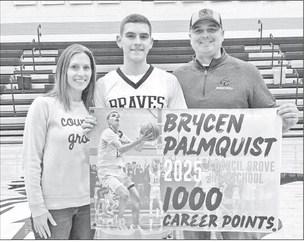 HITS 1000 CAREER POINTS . . . Brycen Palmquist, with his parents Dawn and Lucas Palmquist, celebrated Thursday night as Brycen is now one of only two players in Council Grove High School history to reach 1000 career points. (Gary Carrier was the other.) P