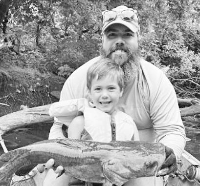 A CATFISHING FAMILY . . . Knute Fox, age 5, is following in his dad Matt’s footsteps with his love of fishing for big catfish in the Neosho River. (Photo: Brent Frazee)