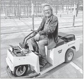 TODAY -- Eric Nelson navigates his many acres of greenhouses on a buggy.