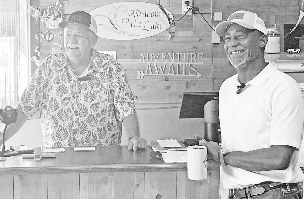 CELEBRATING ANOTHER SUCCESSFUL YOUTH FISHING SEASON . . . Phil Taunton (left) and Chris Kennedy, Secretary of the Kansas Department of Wildlife and Parks (KDWP) enjoyed time together at the Council Grove Marina Wednesday morning. Secretary Kennedy took ti