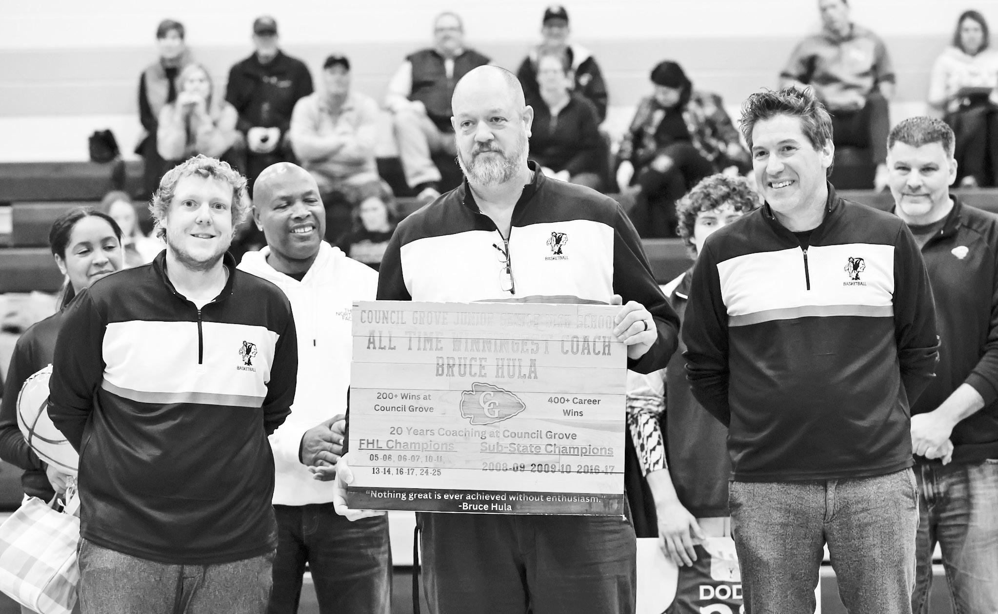 CG’S WINNINGEST COACH OF ALL TIME . . . Coach Bruce Hula, was honored with the special award at last night’s game against Clay Center. In his twenty years of coaching, Coach Hula has coached the Braves to 200+ wins at Council Grove, had 400+ career wi