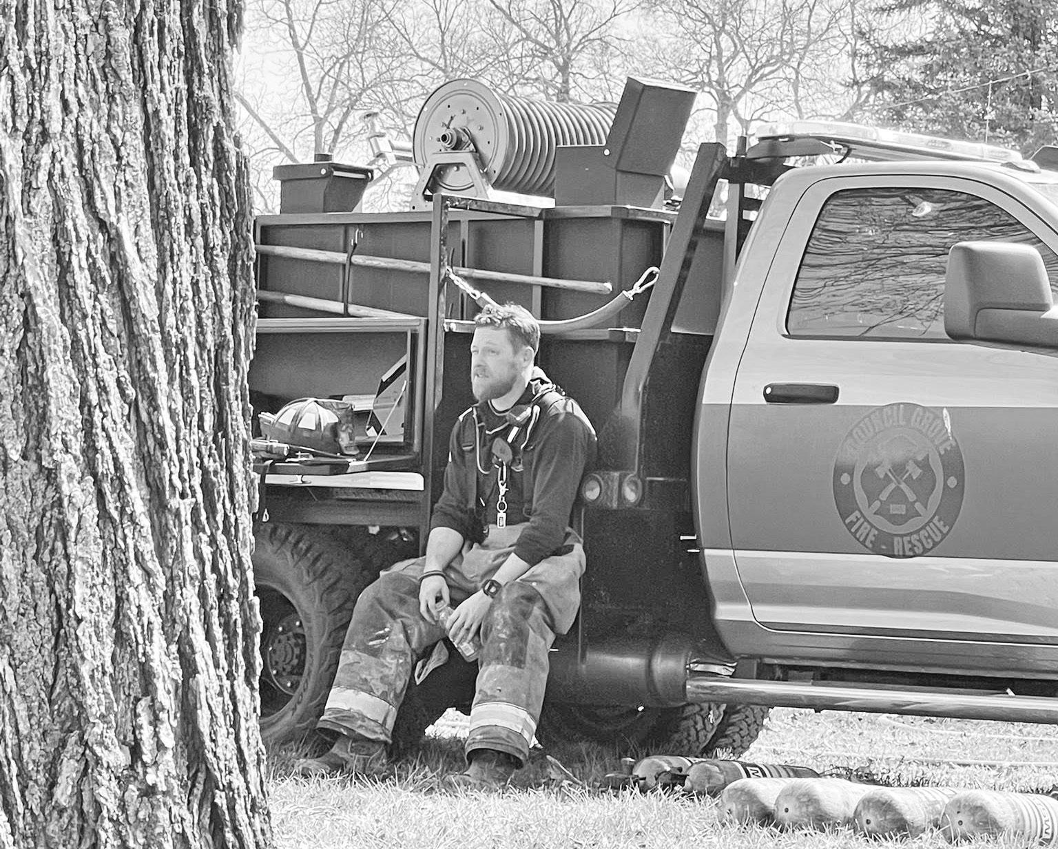 Council Grove Fire Department Lieutenant Zach Tyner takes a break after the Berean Baptist Church fire was extinguished. (Photo by Rebekah Kryger)