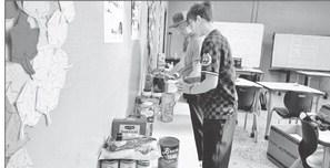 Students Remington Young, left and Maddox McClellan are pictured organizing some of the donated items.