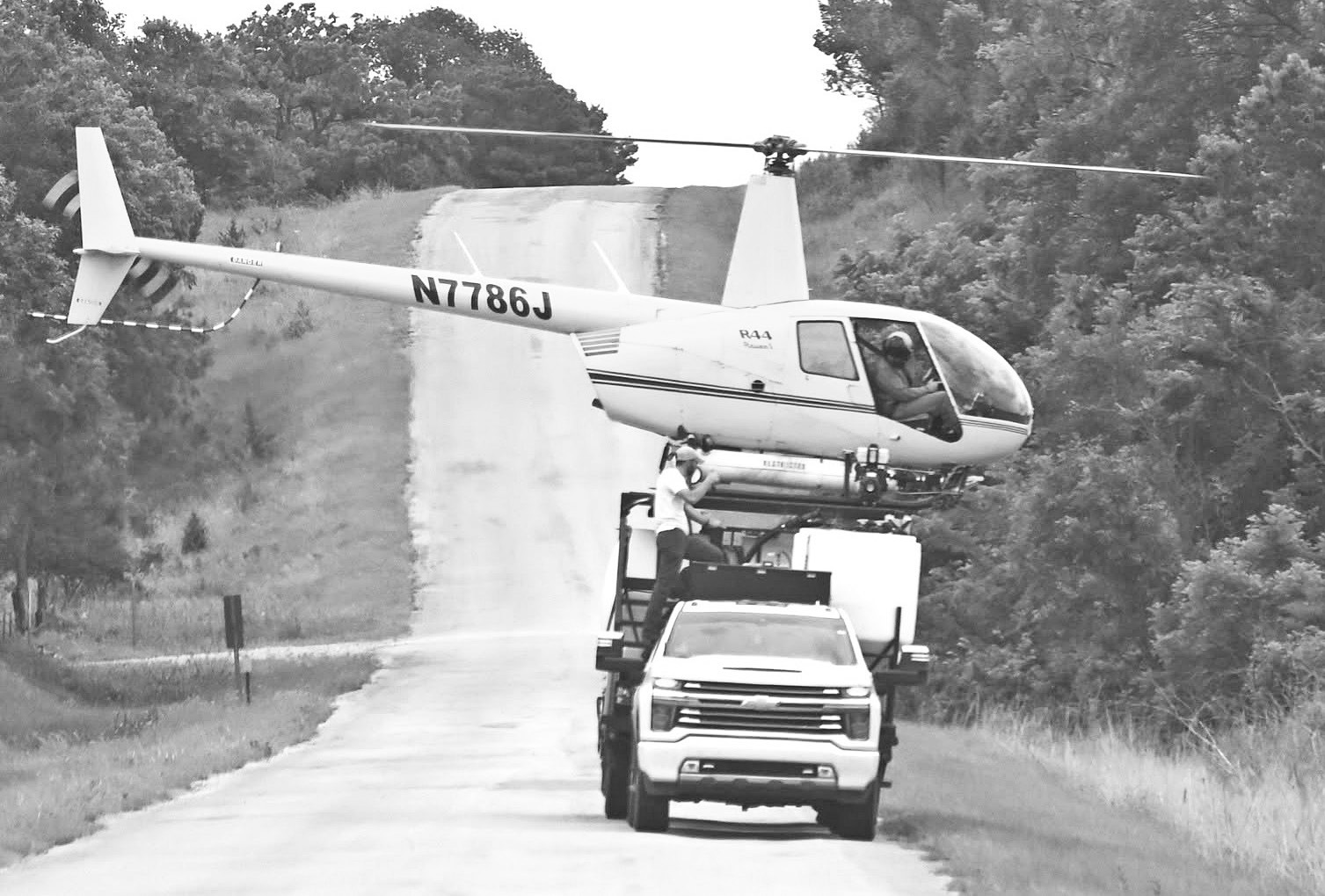 A crop-dusting helicopter was captured having its chemical tank refilled from a truck on Lake Road on June 6. The stunning photo was captured by Chase County resident Theresia Martin.