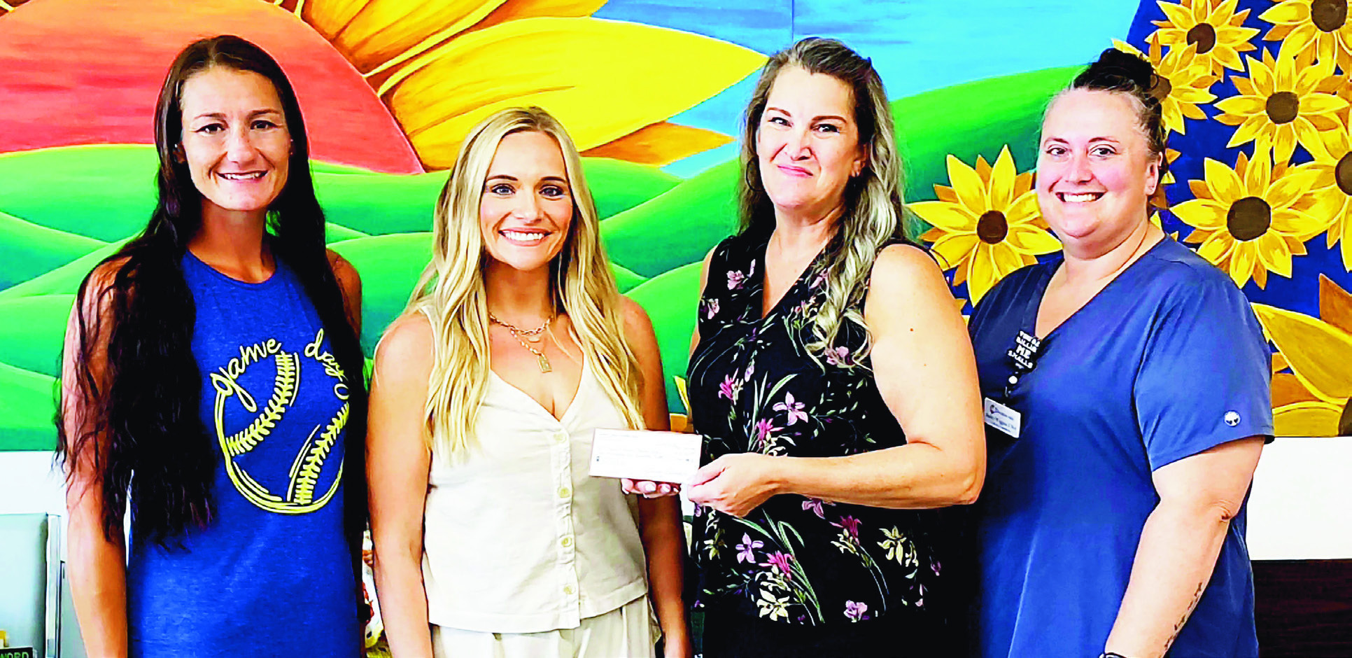 The Council Grove Softball Club recently donated $2,400 to the Council Grove Senior Center from proceeds of its benefit softball tournament. Pictured left to right are: Genna Edwards, Ricki Hughes, Tracey Oltmanns (CG Senior Center Site Manager), and Bailey Wiggins.