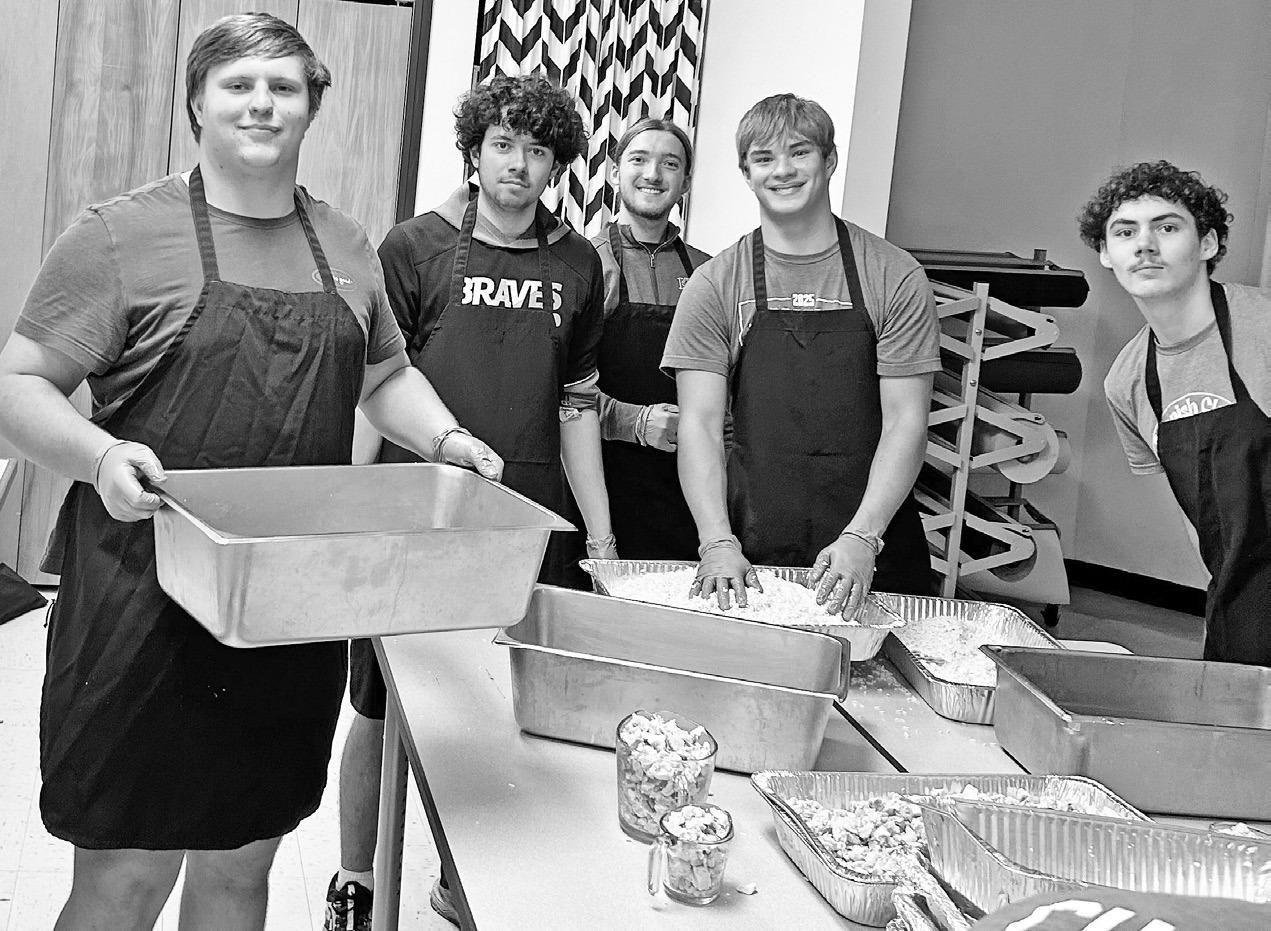 PREPPING meals for the Kids Feeding Kids project. Pictured left to right are - Maddox Ziegler, Maxton Villalobos, Daniel Most, Kayden Hewitt and Cooper Askins.