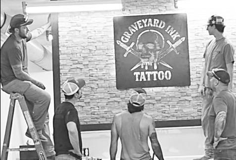 It was a group effort installing a Graveyard Ink sign in the new studio. From left to right are Cooper Blackledge, Scott Baughman, Corbyn Miller, Tisen Flatery (next to sign) and Chris Blackledge.