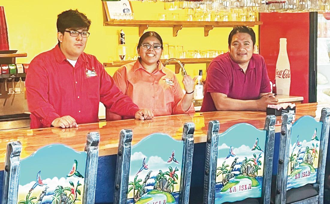 La Isla Authentic Mexican Restaurant and Cantina, in Herington, is family-owned and prides itself on delicious authentic food. Pictured at the bar are brother Adan Carvajal (left), sister daughter Lorena Carvajal and father Adan Ramirez. Note the colorful