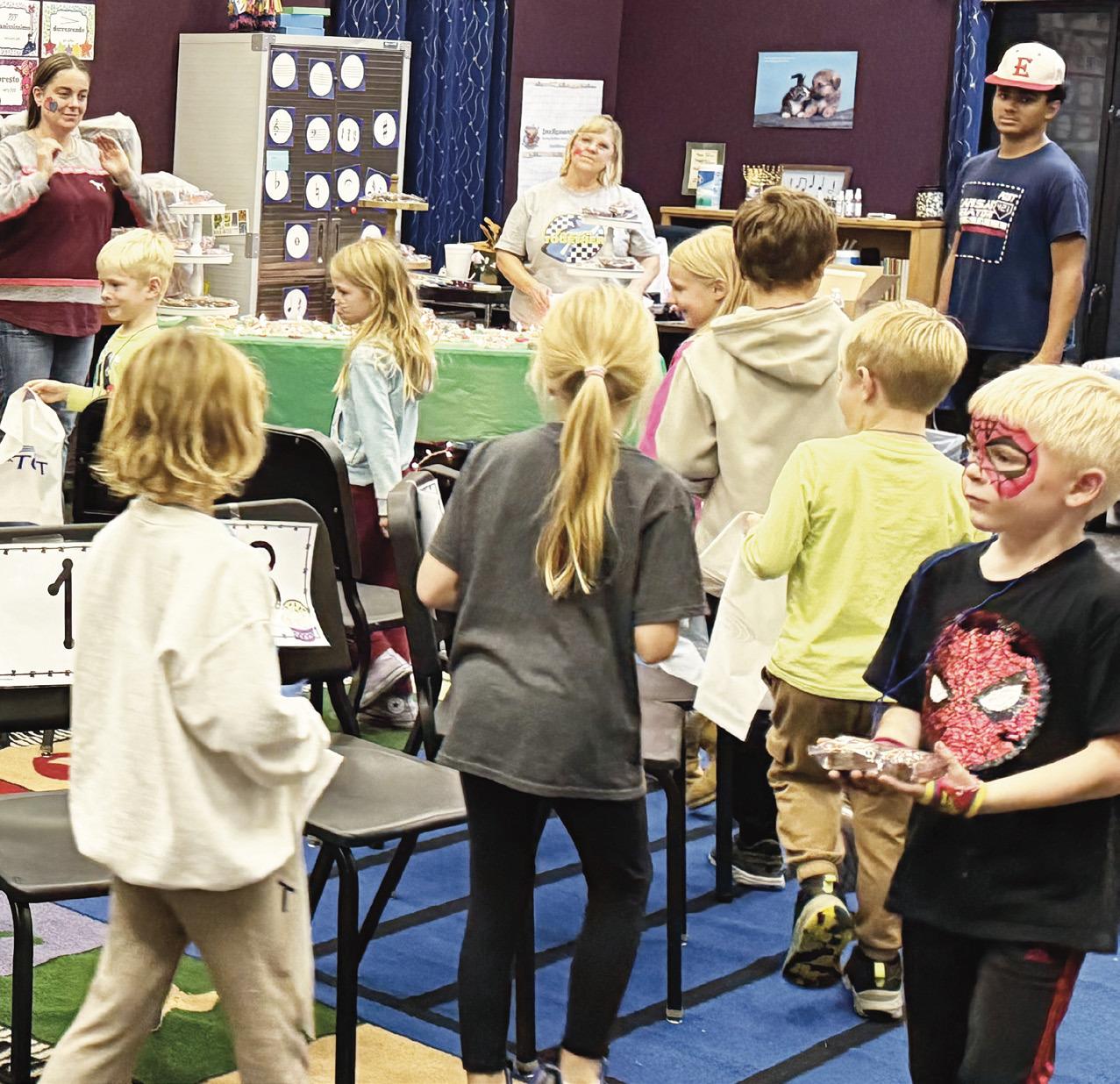 CARNIVAL FUN -- An old-fashioned, fun carnival was held at Council Grove Elementary recently. The CGES PTO decorated in a festive way and provided popular games of old. Above are left to right James Horn and PTO members Kailea Horn and Kaitlin Johnson. Be