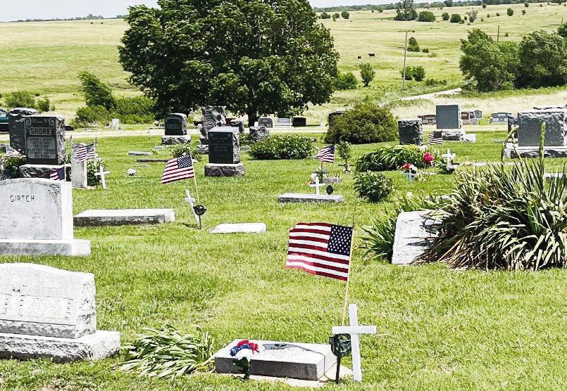 The above photo of the White City Cemetery shows the flags that the Anderson family place on veterans’ graves, as well as the white cross placed on the same graves by Steve Ash.