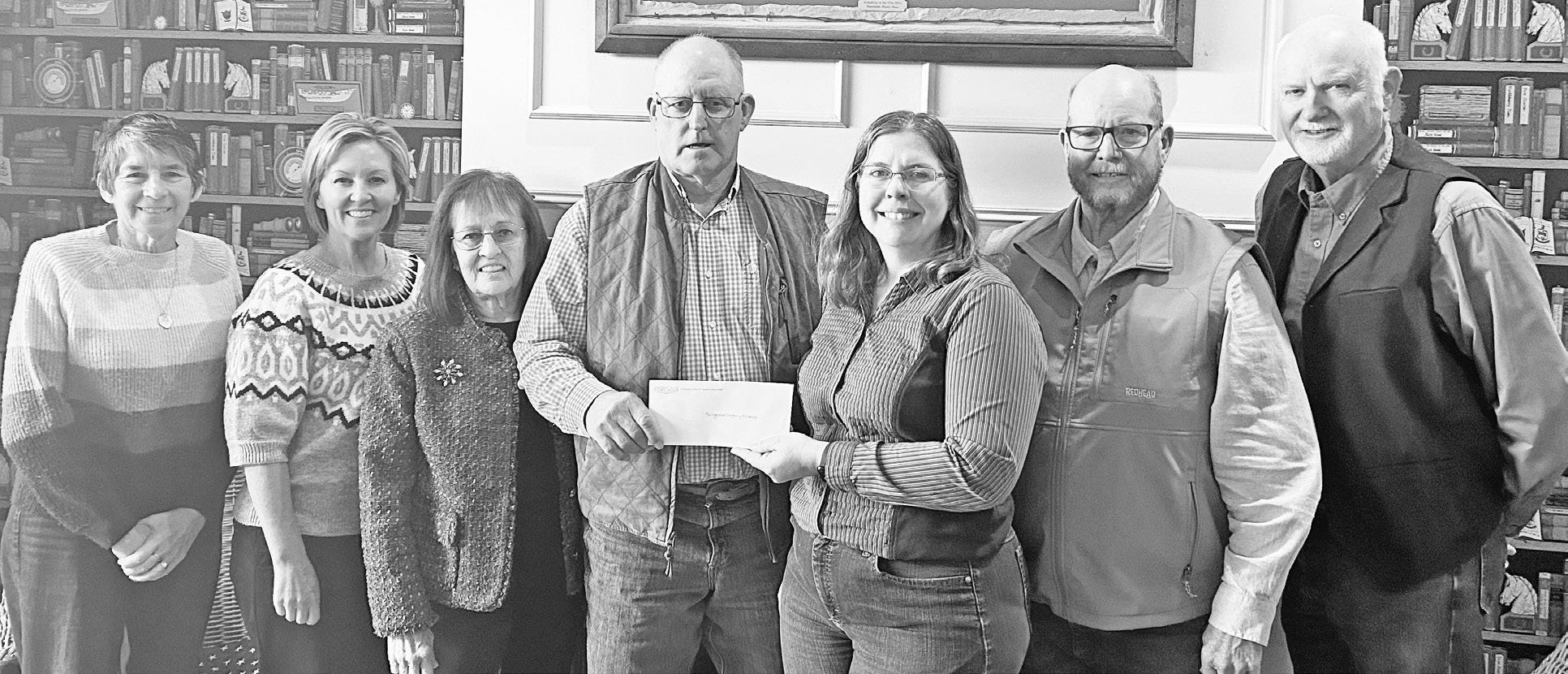 PRESENT FINAL GIFTS -- Two locals on the far left of the photo, Debbie Miller and Julie Hower, and other members of the Symphony in the Flint Hills board members presented a final gift to the Tallgrass Legacy Alliance, one of four Flint Hills area non-pro