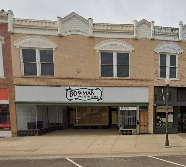 SPROUTING A NEW LOOK . . . 124 W. Main, known as the Cleek Building, has a new look after a couple of years of renovation. The work on the exterior of the building, shown as before and after in the photos, was delayed due to needing approval from Historic