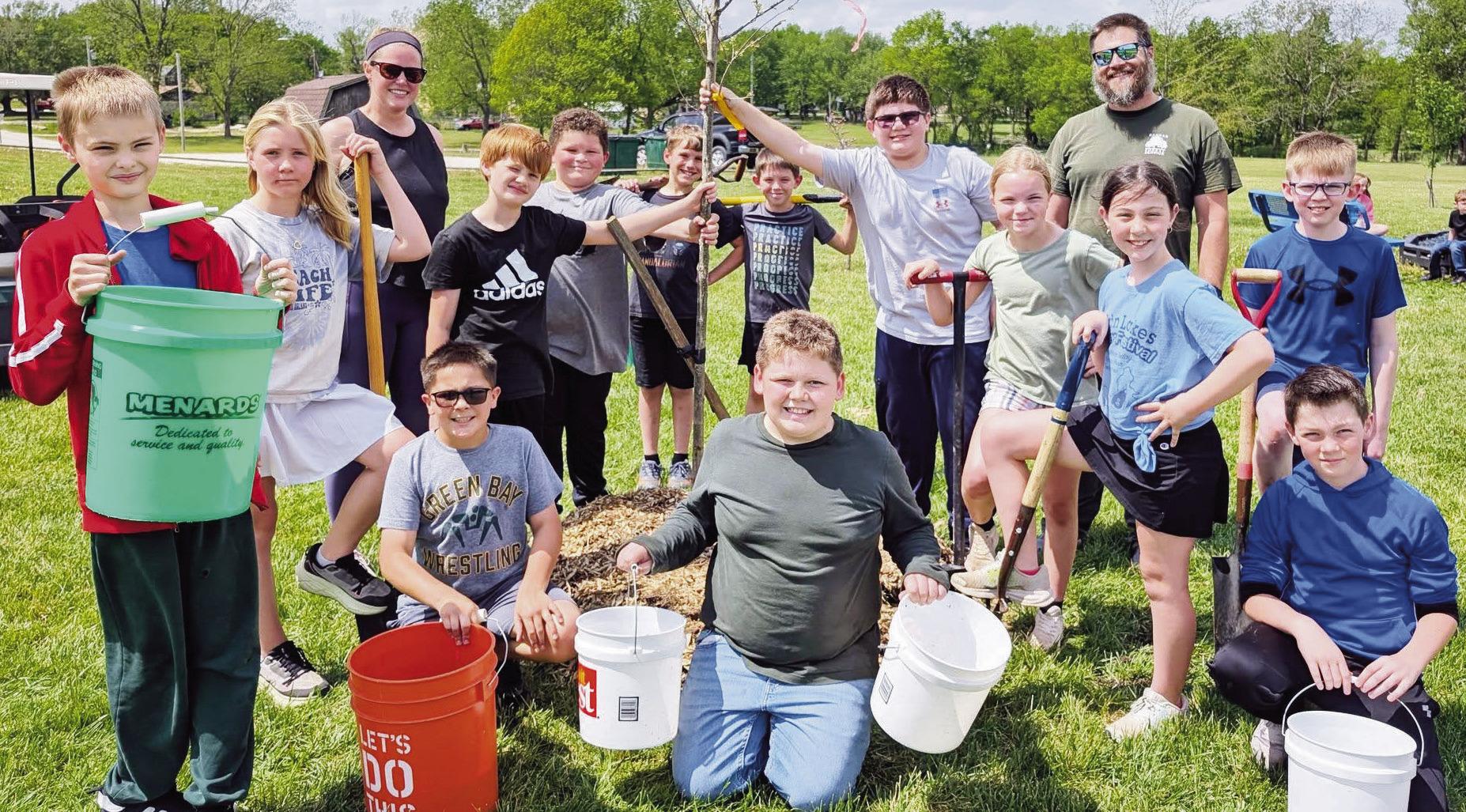 A chinkapin oak was planted at PHES for Arbor Day 2026 to provide shade for kids at the school playground. Pictured from left to right are Henry Armbrust, Averi Odell, Laura Armbrust, Ethan Holub, Lane Glacken, Daxton Thrasher, Stephen Prince, “Bob” t