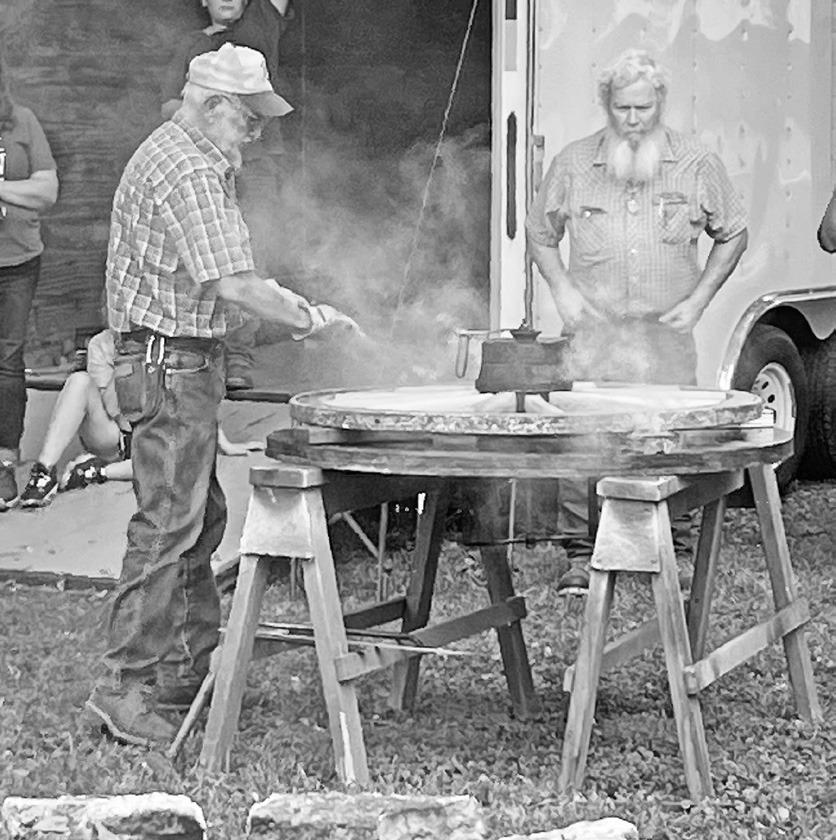 There were good crowds at the Heart of the Flint Hills Chapter of the Santa Fe Trail Association’s Wagon Show on Friday and Saturday as Wheelwright Don Werner demonstrated how to shrink a steel tire on a wagon wheel. It was first heated in a hot fire (l