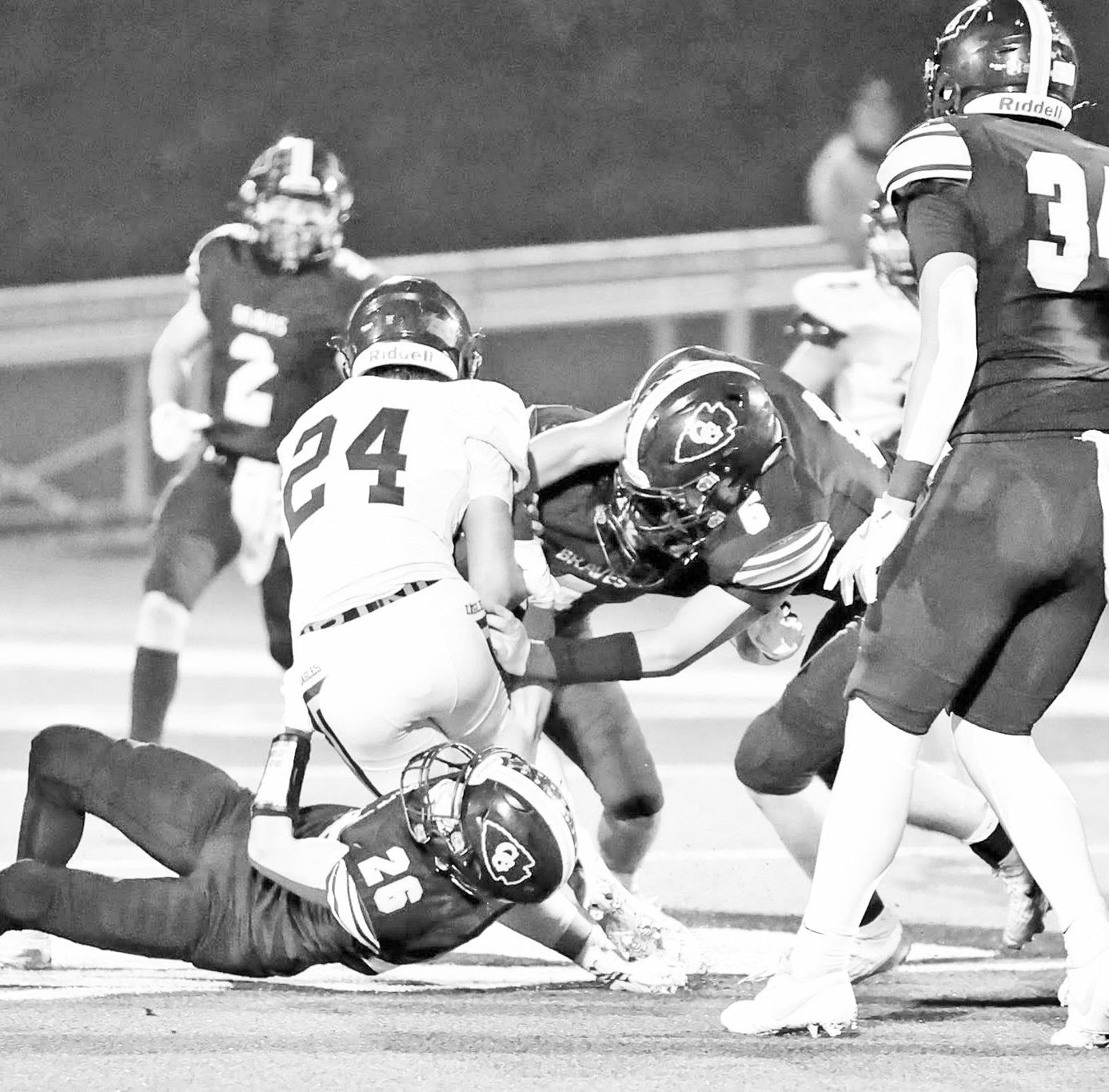 The Braves defense was all over the Silver Lake Eagles Friday night, as displayed in this photo captured by Amber Weeks. The defense made important stops to the Eagles momentum although the Silver Lake ended up winning 17-8. Photo: Amber Weeks