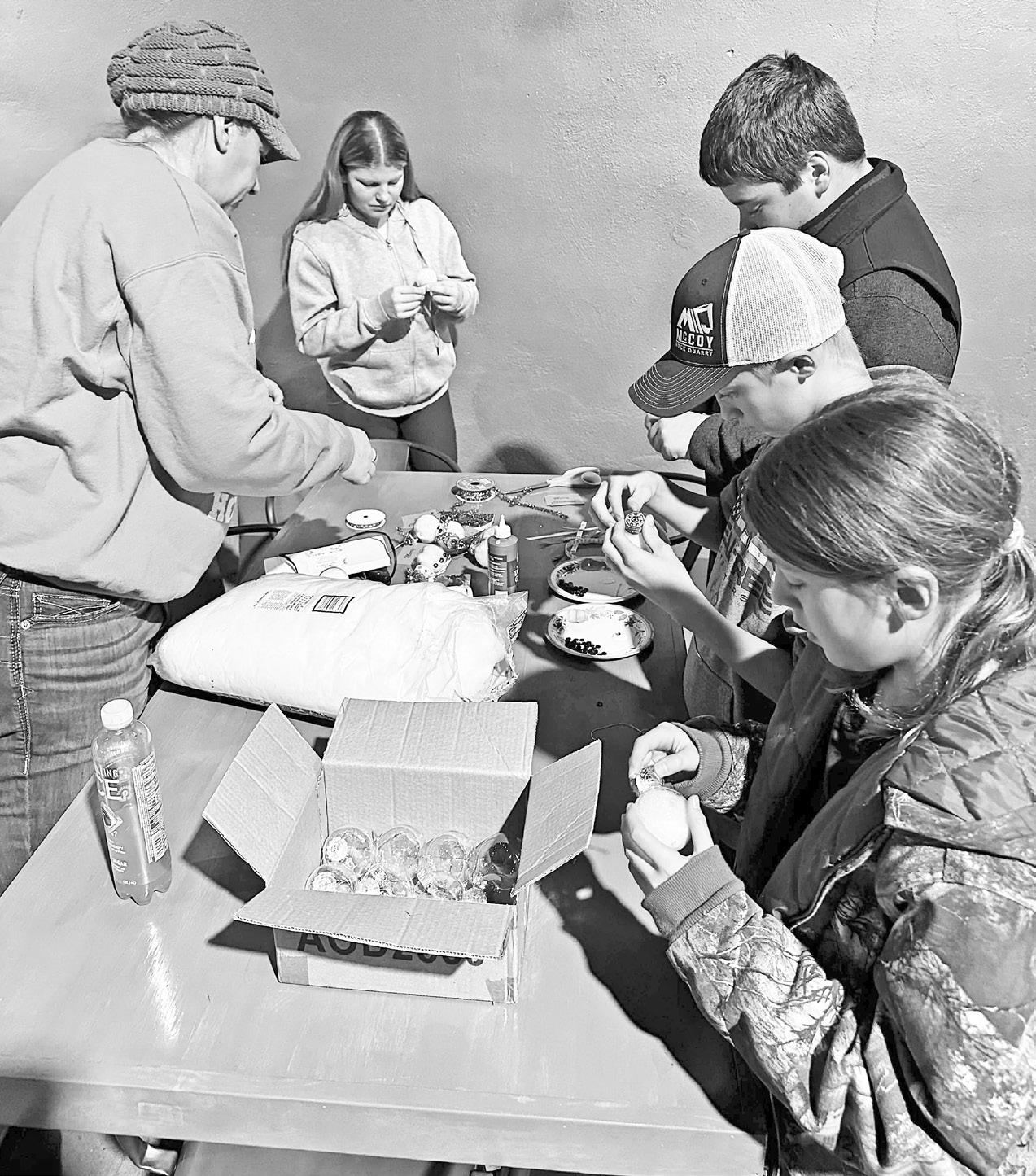 Members of the Neosho Valley 4-H Club are pictured making Christmas ornaments last December for residents of Morris County Assisted Living.