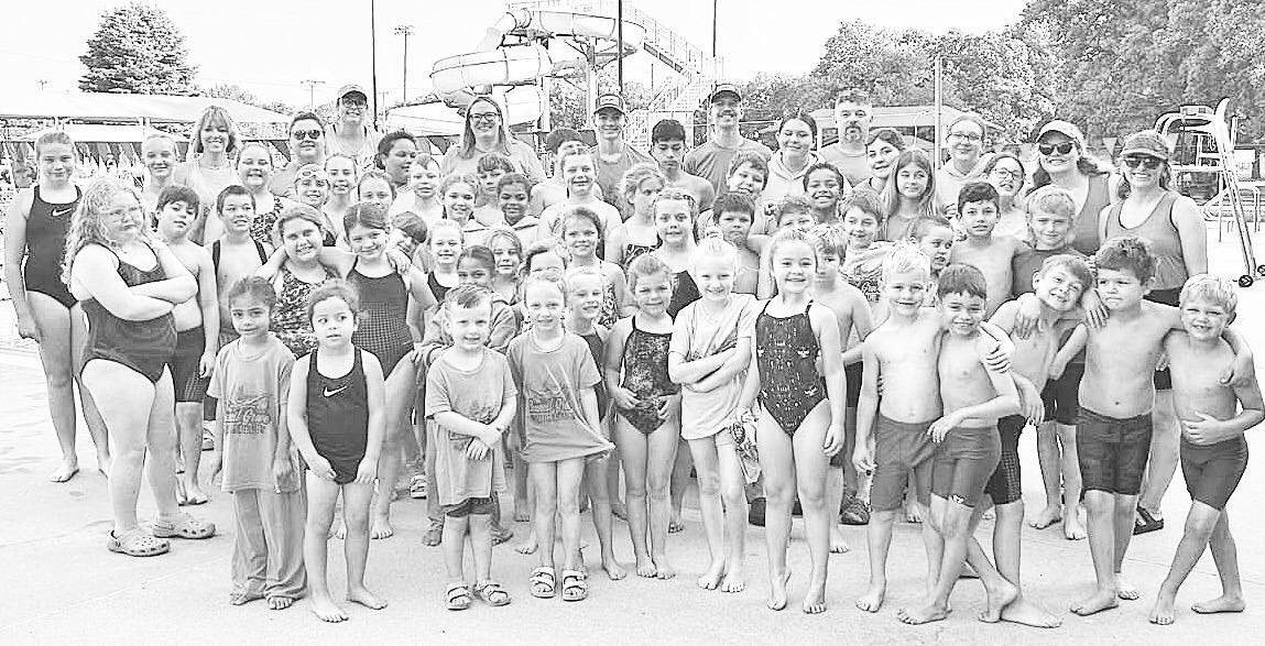CG’S BACK! Council Grove Swim Club, coaches, club organizers and volunteers celebrate with a team photo on Saturday, June 14, after a successful Council Grove Invitational with top notch teams in attendance. There were nearly 90 swim events. Council Gro
