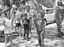 CHAMPION SPITTER -- Dalton Amick, age 7 of Alma, launches a watermelon seed 12’ 7” for first place in the 7 and under division at the Council Grove Marina’s watermelon seed spitting contest on Saturday.