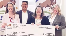CHECK FOR REVITALIZATION -- Lisa Schlesener, Rural Champion for the City of Herington, recently received a $25,000 check to assist in revitalization of downtown Herington. From left to right are: Kerri Falletti, Grassroots Strategy Developer for Office of