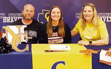CHEERING INTENT . . . Faith Blosser signed a National Letter of Intent to Cheer at Neosho County on Monday. Pictured with Faith are her parents, Jesse Blosser and Tabitha Barrett.