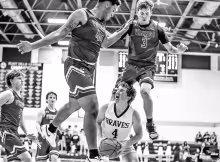 FIGHTING THE VIKINGS -- Council Grove Brave and Senior Drew Buchman found himself surrounded by Mission Valley Vikings when the Braves hosted Mission Valley. The Braves came away with a 49-36 victory. (Photo by Brandy Villalobos)