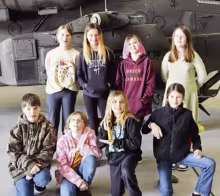 LEARNING AT FT RILEY . . . Teacher Lori Pollock accompanied Prairie Heights Elementary School 5th graders to Ft. Riley as part of their Starbase learning experience. Pictured in front of the Apache Helicopter, from left to right, are back row: Alexis Zaja