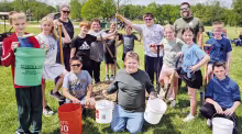 A chinkapin oak was planted at PHES for Arbor Day 2026 to provide shade for kids at the school playground. Pictured from left to right are Henry Armbrust, Averi Odell, Laura Armbrust, Ethan Holub, Lane Glacken, Daxton Thrasher, Stephen Prince, “Bob” t