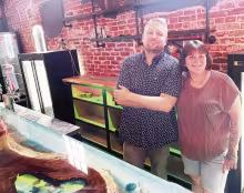Frankie Greco and Maesha Pool paused from their work Monday, as they readied the Cut &amp; Chute Bar, which is scheduled to open Friday, May 29. at 200 W. Main in Council Grove.