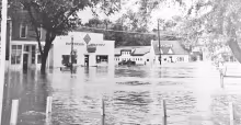New life for an old building . . . The new CrossWinds location is pictured in the old 1950 flood photo as an Allis Chalmer dealership owned by Harrison Pat Patterson and later by his son Laurence Maddux. The building is now remodeled into CrossWinds Couns