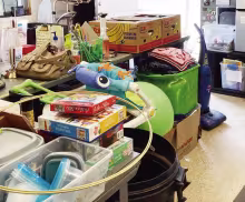 COMMUNITY DONATIONS consisting of bags, boxes and bins were left at the Community Thrift Store after the citywide garage sales during the weekend.