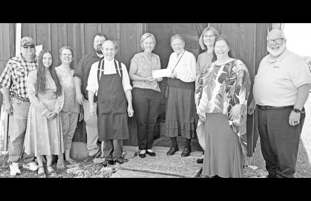 On Wednesday, representatives from the Young Foundation presented The Historic Preservation Corporation with a grant check in the amount of $34,000 to help complete the restoration of the 1858 Atkinson log house, which is housed inside a barn at the Trail
