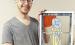 Adam Koci of Emporia holds “Prairie Stroll,” one of seven stained glass pieces now on display in the Council Grove Republican windows through Street Gallery KS, a division of the Bowers Center.