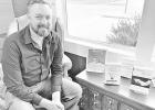 ACCORD HOSPICE -- Nick French, assistant director of Accord Hospice, is pictured with books concerning hospice care. The books are available at the Council Grove Public Library. “National Hospice and Palliative Care Month: Myths and Reality”