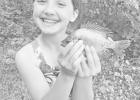 Evelyn Arredondo, 8 years-old ~ while practicing the Summer of No, no telephones or electronic gadgetry on the old family farm near Kelso, Evelyn caught her prize winning sunfish and a smile to last a lifetime at the north end of Council Grove Reservoir.
